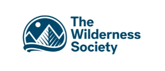 Logo of The Wilderness Society featuring mountains, a sun, and water in blue tones.