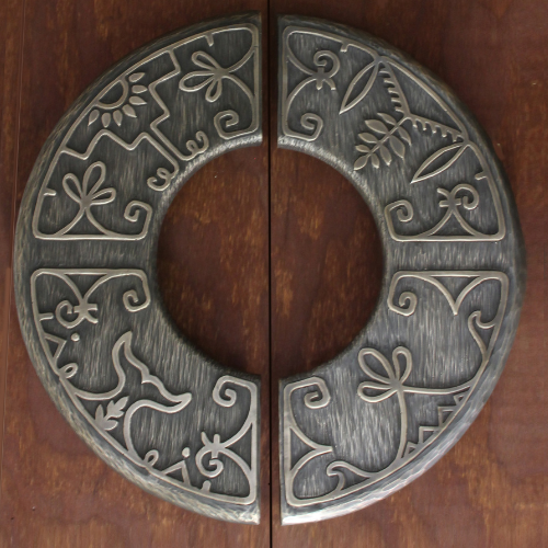 Two cast bronze door handles with Wabanaki double curve design in relief.
